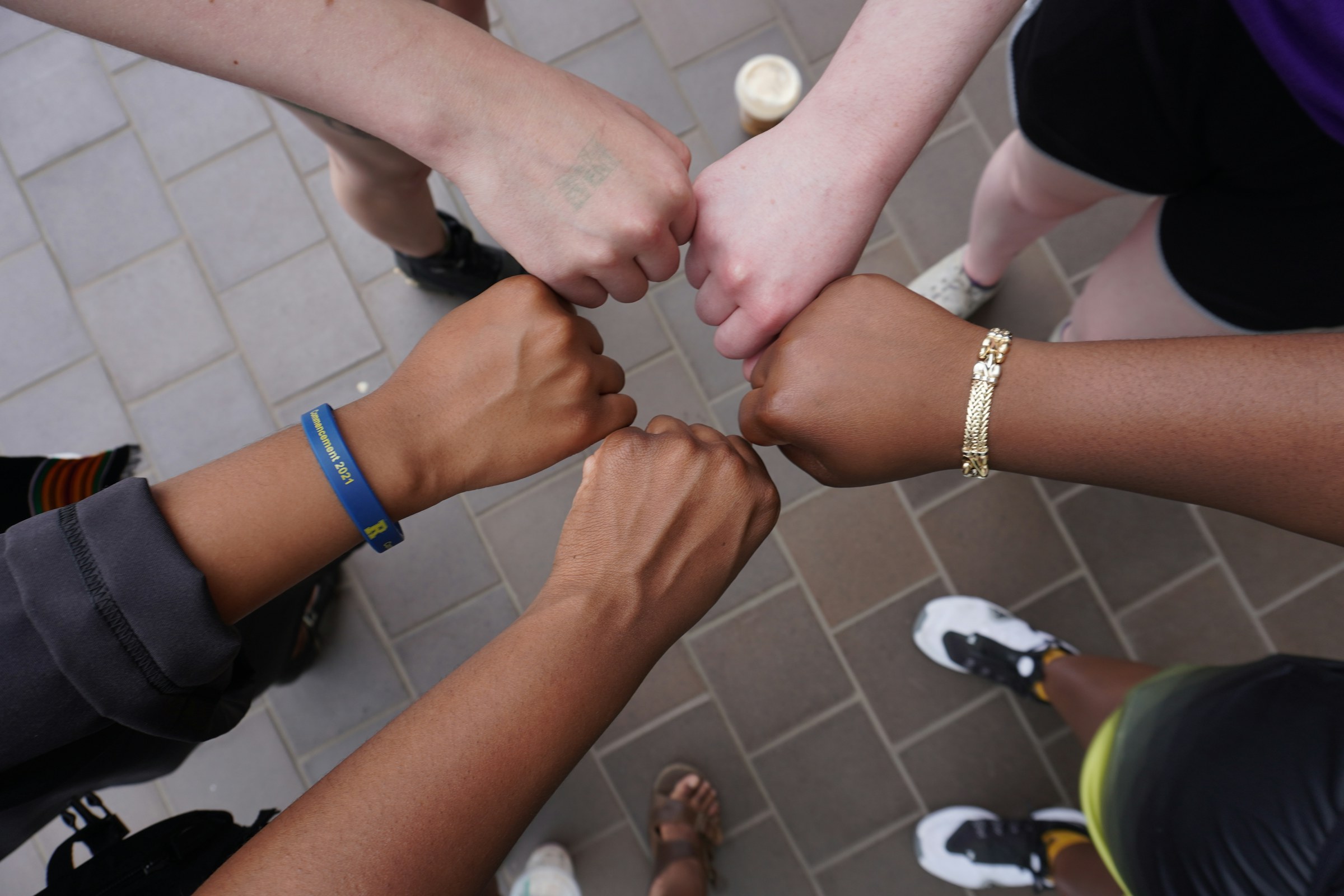 A diverse group joining hands in mutual support