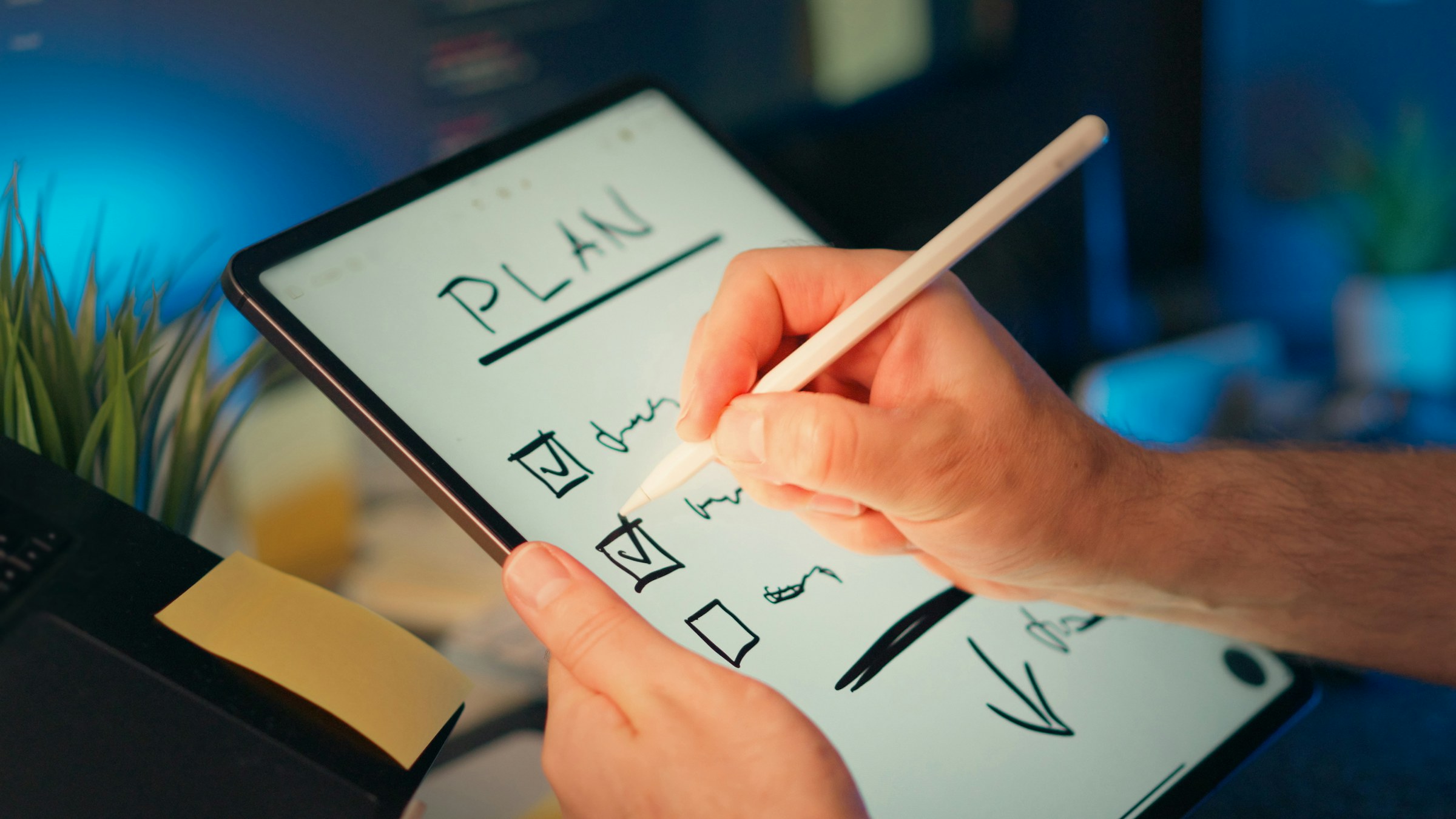 A person building a clear plan on a digital tablet