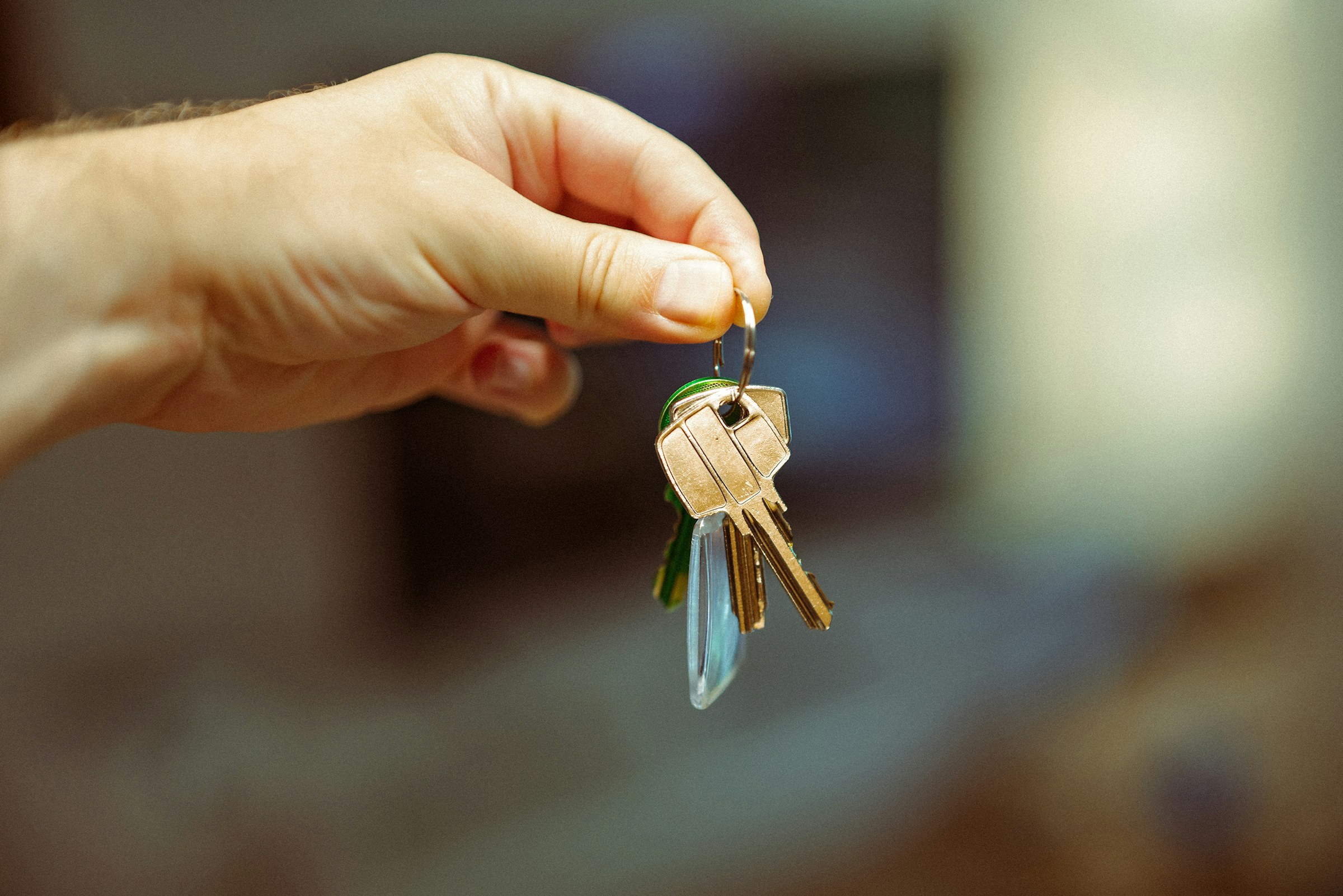 A hand holding keys that represent a housing opportunity